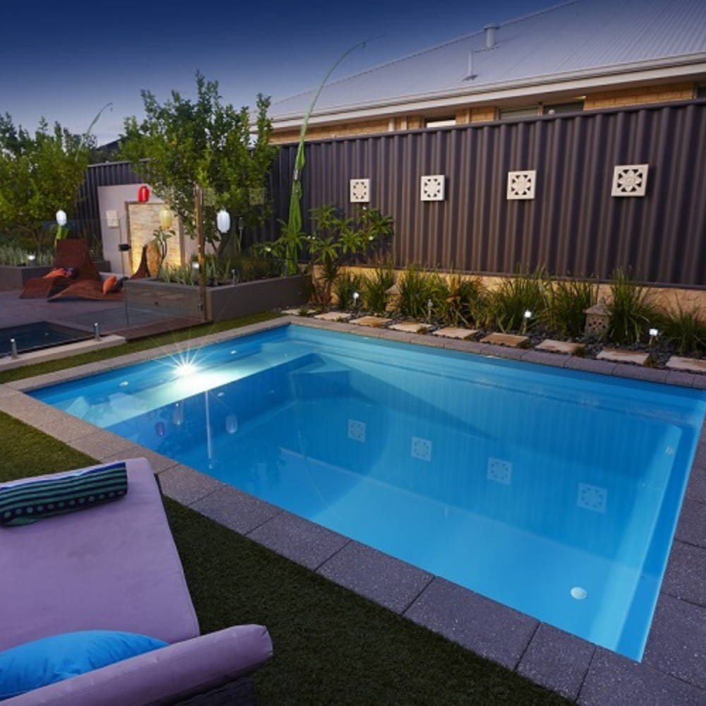 Billabong Plunge 6.5m with coping tiles and surrounding turf